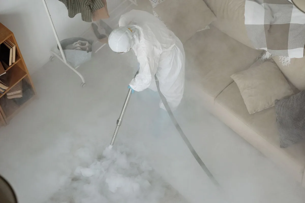 Biohazard cleanup technician in protective equipment, South End, Boston, MA
